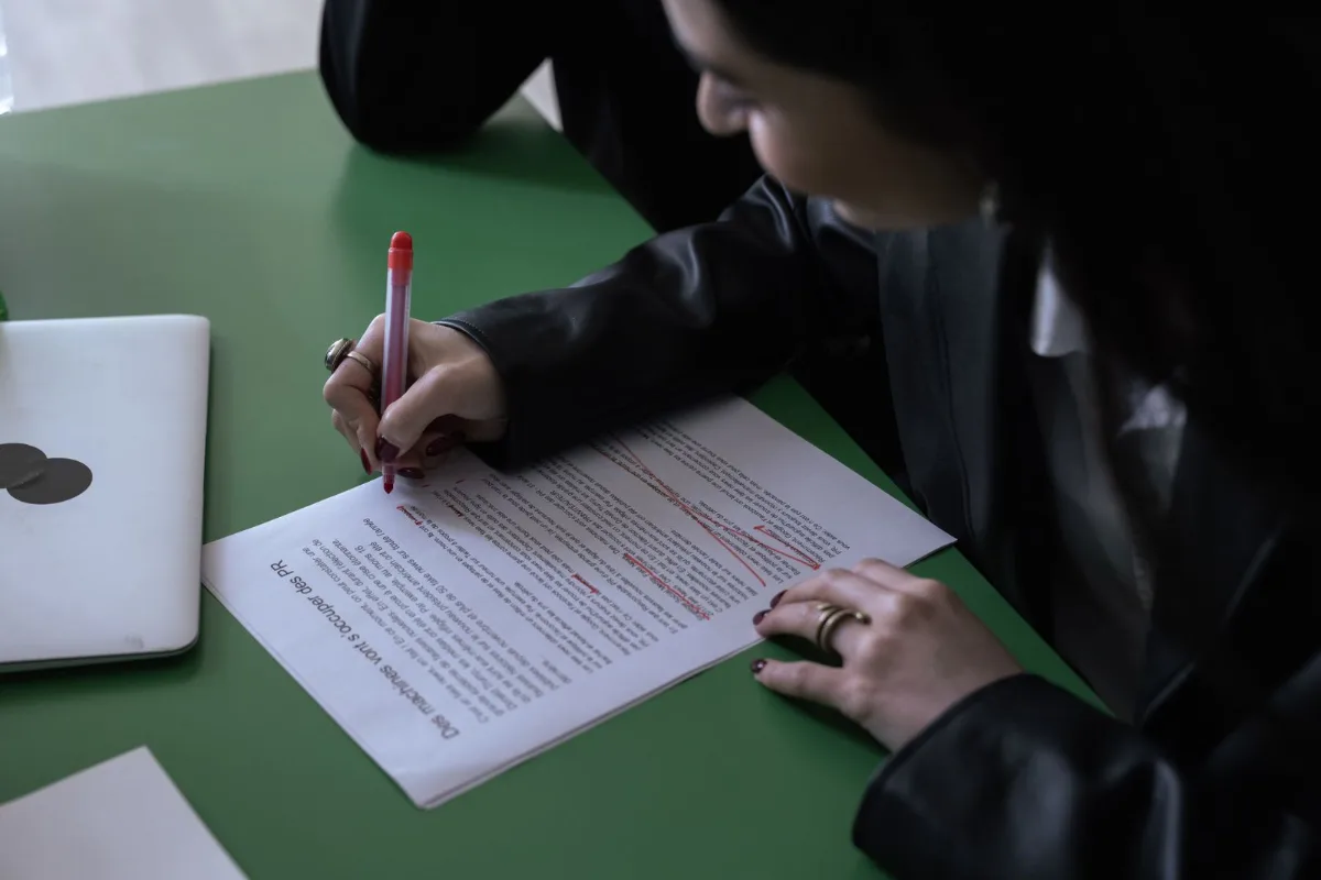 A marked-up printed blog post draft with an owner's handwritten corrections in the margin