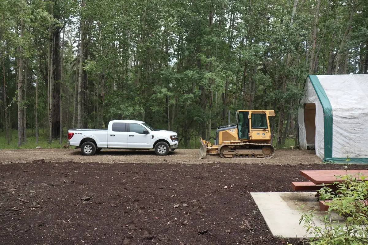 A pickup truck with fresh vinyl lettering parked outside a house under construction in a Wake County subdivision