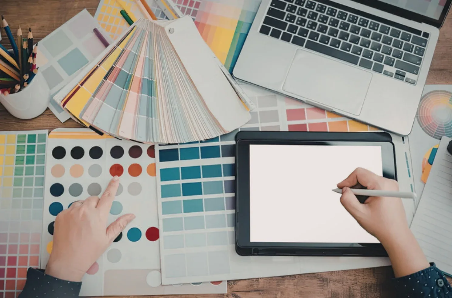 Graphic design workspace with brand materials