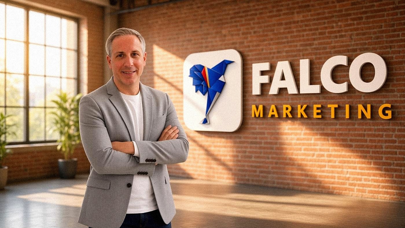 Trey Linder, founder of Falco Marketing, in front of the Falco Marketing sign