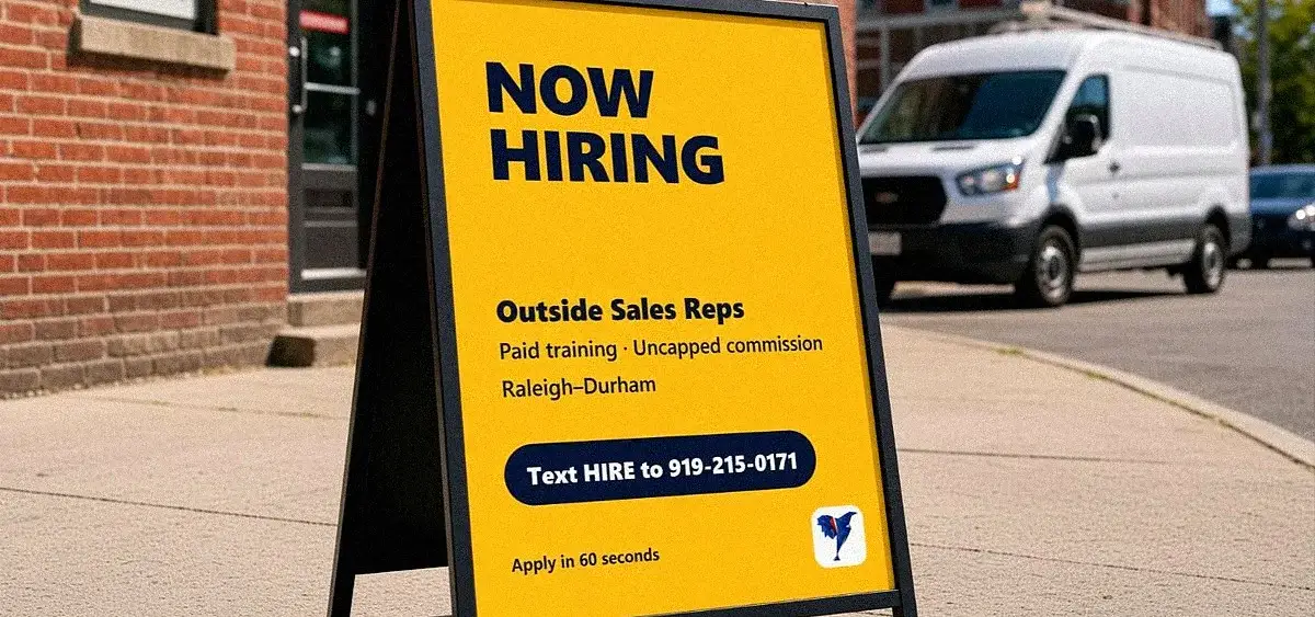 Now Hiring A-frame sign on a sidewalk outside a local business