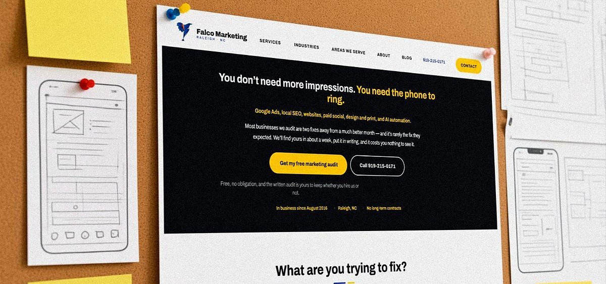 Printed website page mockups pinned to a design wall at Falco Marketing in Raleigh