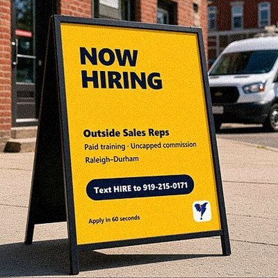 Now Hiring A-frame sign on a sidewalk