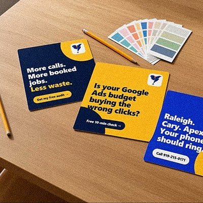 Three printed social media ad creatives on a desk