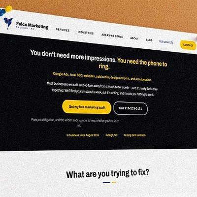 Printed homepage mockups pinned on a design wall